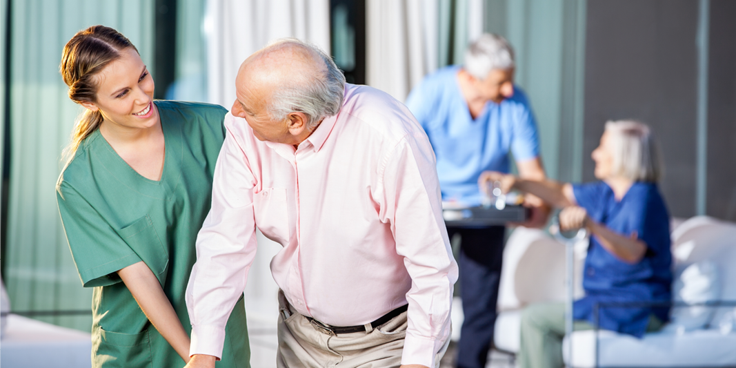 Caretaker assists elderly patient